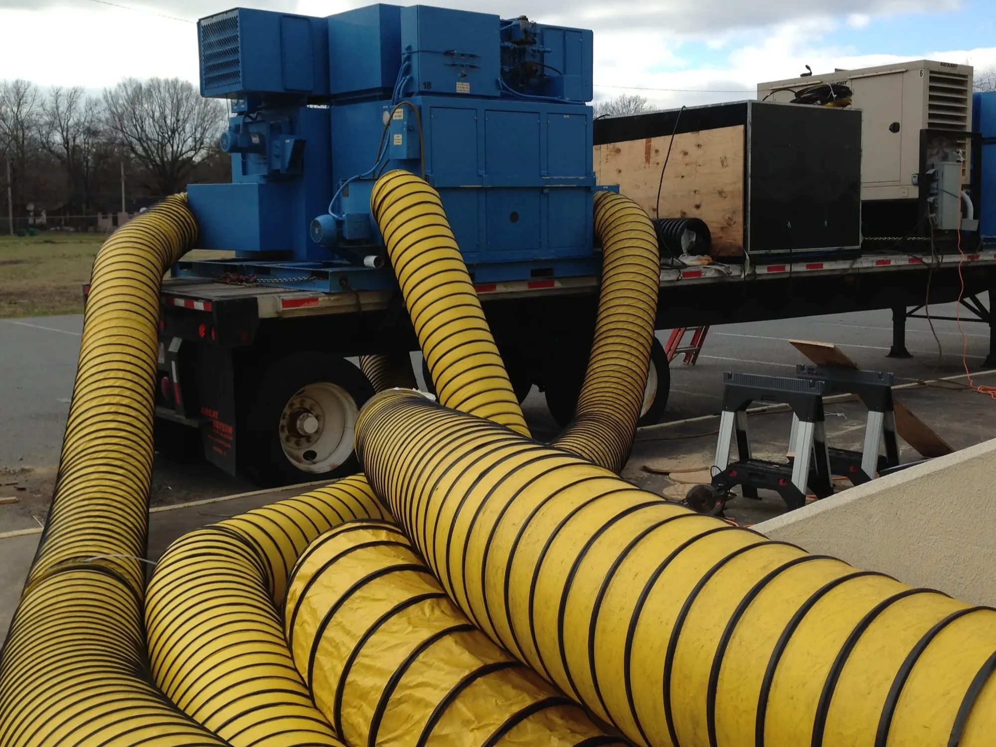 Trailer-mounted drying equipment with temporary ducting at a municipal property